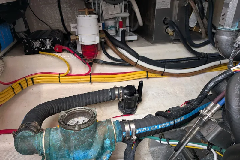 Slide: The Image of Engine compartment of a 2008 Back Cove 29 boat, showcasing hoses and wiring. - 45