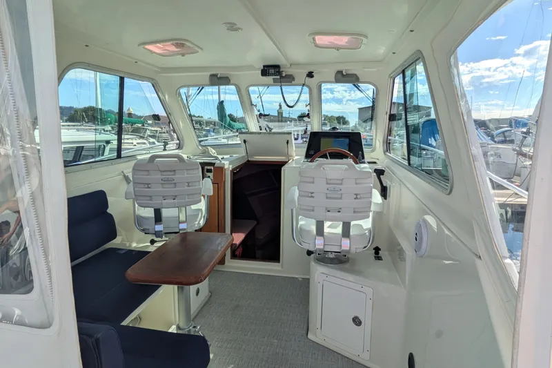 Slide: The Image of Interior of a 2008 Back Cove 29 boat with seating and helm station. - 15