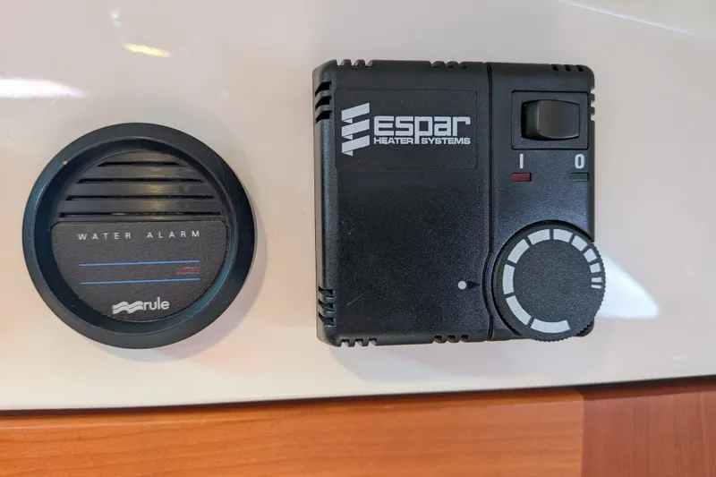 Slide: The Image of Water alarm and Espar heater controls on 2008 Back Cove 29 boat dashboard. - 33