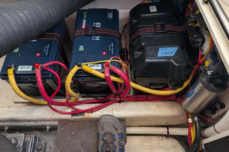 Slide: The Image of Battery compartment of a 2008 Back Cove 29 boat with wiring and connections. - 47