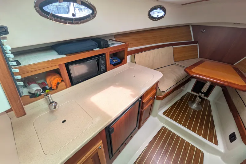 Slide: The Image of Interior of 2008 Back Cove 29 boat with kitchenette and seating area. - 24