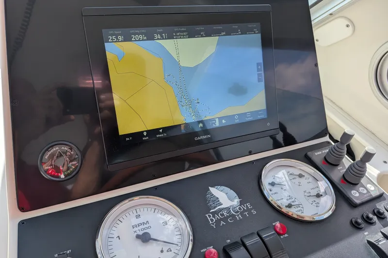Slide: The Image of Garmin navigation system on 2008 Back Cove 29 yacht dashboard with gauges and controls. - 40