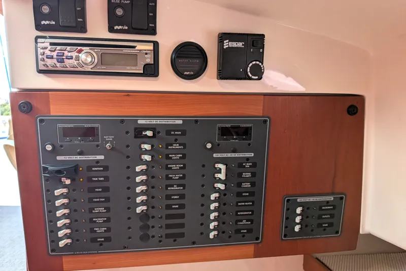 Slide: The Image of Electrical control panel on a 2008 Back Cove 29 boat, featuring switches and stereo system. - 32