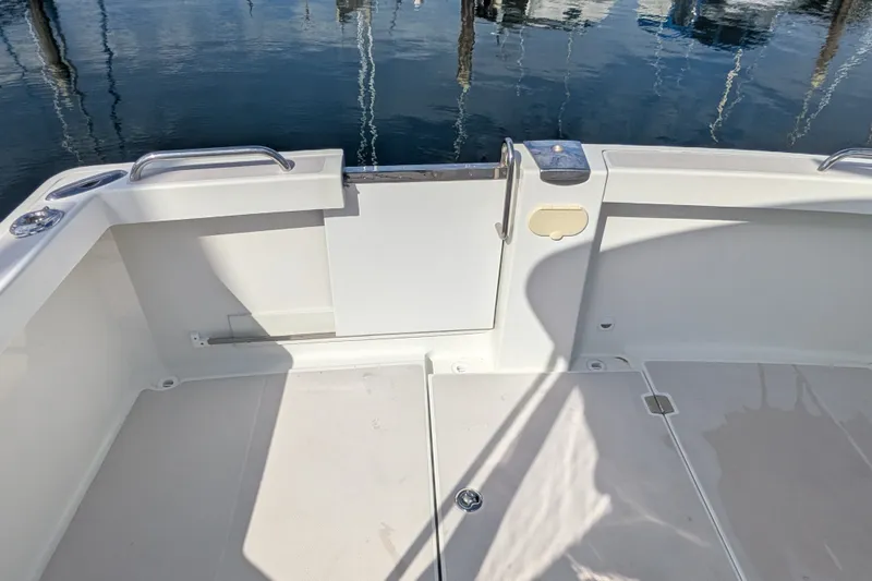 Slide: The Image of 2008 Back Cove 29 boat deck with open transom door, reflecting water surface. - 23
