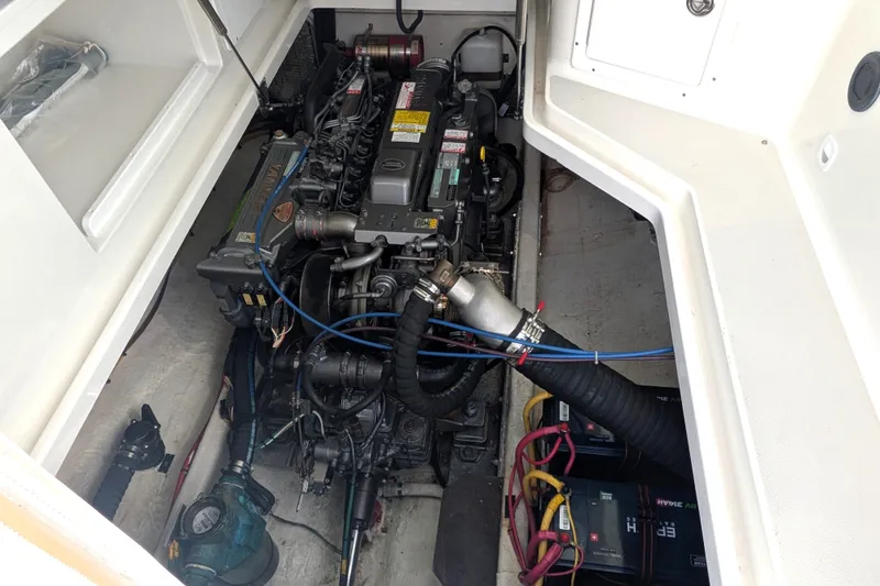 Slide: The Image of Engine compartment of a 2008 Back Cove 29 boat, showcasing mechanical components and wiring. - 42