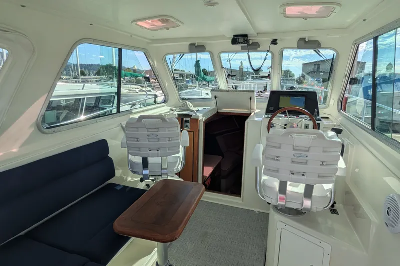 Slide: The Image of Interior of a 2008 Back Cove 29 boat with helm, seating, and navigation equipment. - 14