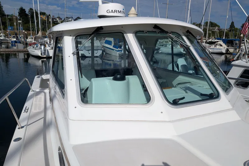 Slide: The Image of 2008 Back Cove 29 boat docked at marina with Garmin equipment visible. - 8