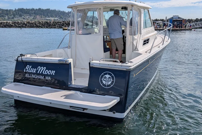 Slide: The Image of 2008 Back Cove 29 boat named "Blue Moon" in Bellingham, WA, on the water. - 4