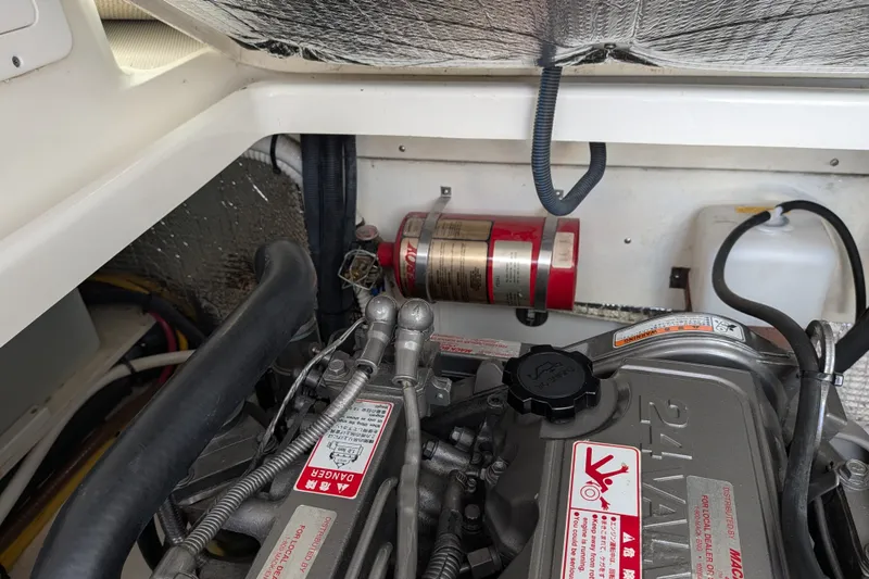 Slide: The Image of Engine compartment of a 2008 Back Cove 29 boat, featuring a fire extinguisher and engine components. - 43