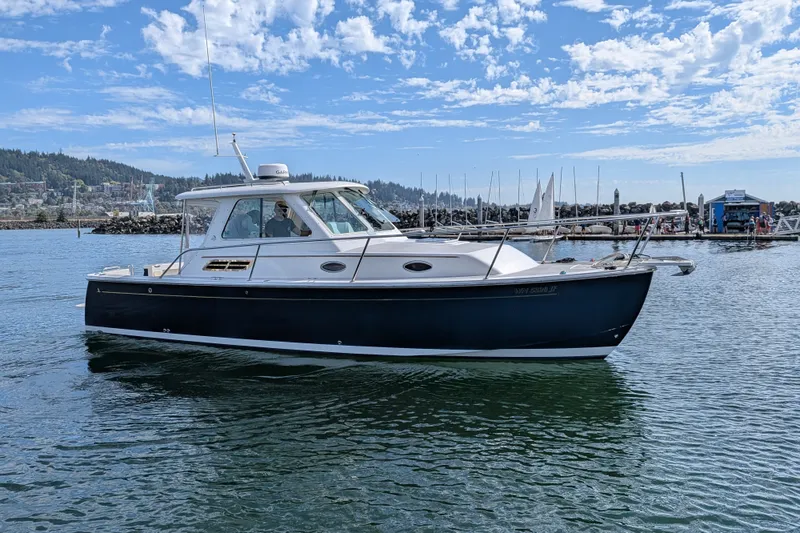 Slide: The Image of 2008 Back Cove 29 boat on calm water with scenic marina background. - 52