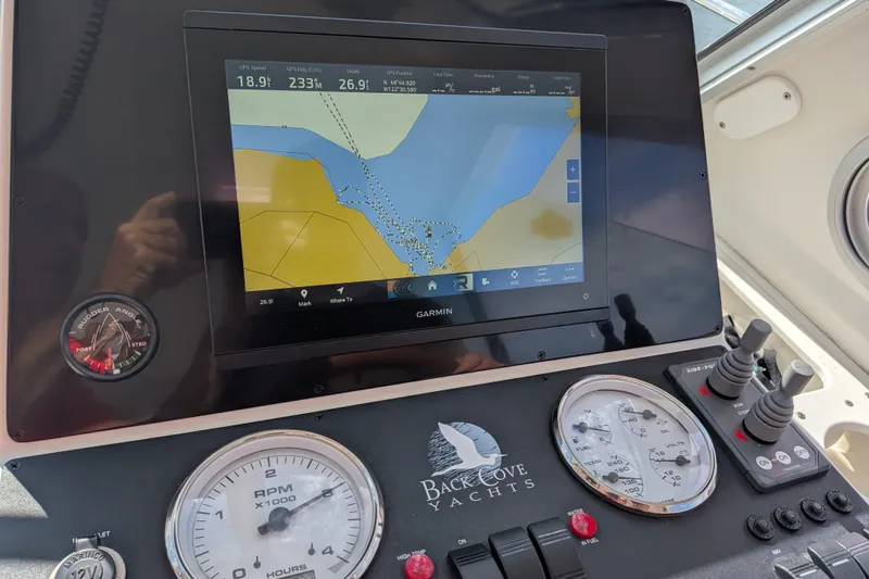 Slide: The Image of Dashboard of a 2008 Back Cove 29 yacht with navigation display and gauges. - 39