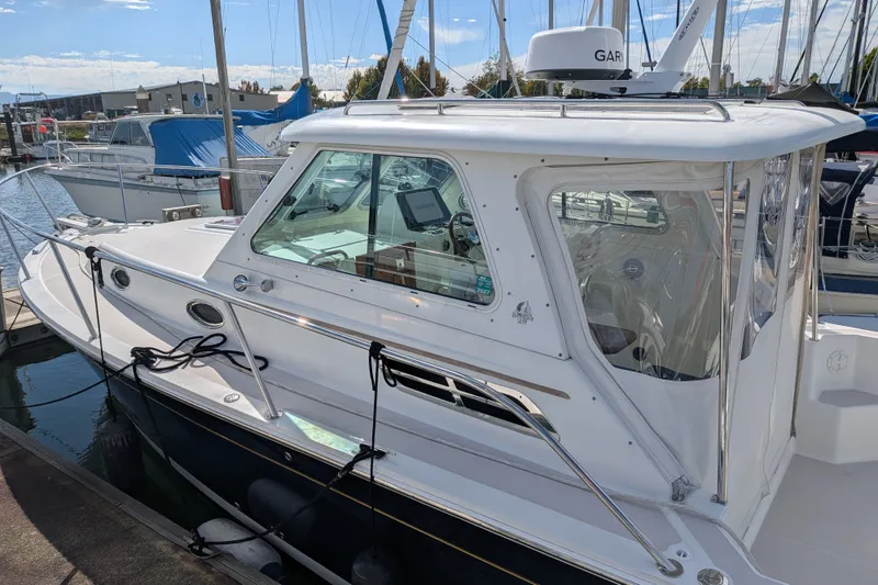Slide: The Image of 2008 Back Cove 29 boat docked at marina, featuring sleek design and modern equipment. - 10