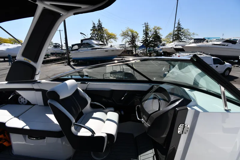 Slide: The Image of 2021 Monterey 278 Super Sport boat interior with helm and seating area. - 22