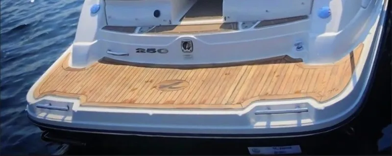 Slide: The Image of The image shows the stern of a Sea Ray SLX 250 boat with a wooden platform. - 4