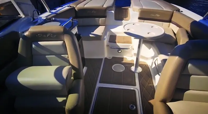 Slide: The Image of The image shows the cockpit of a 2012 Sea Ray SLX 250 boat with comfortable seating and a table. - 5
