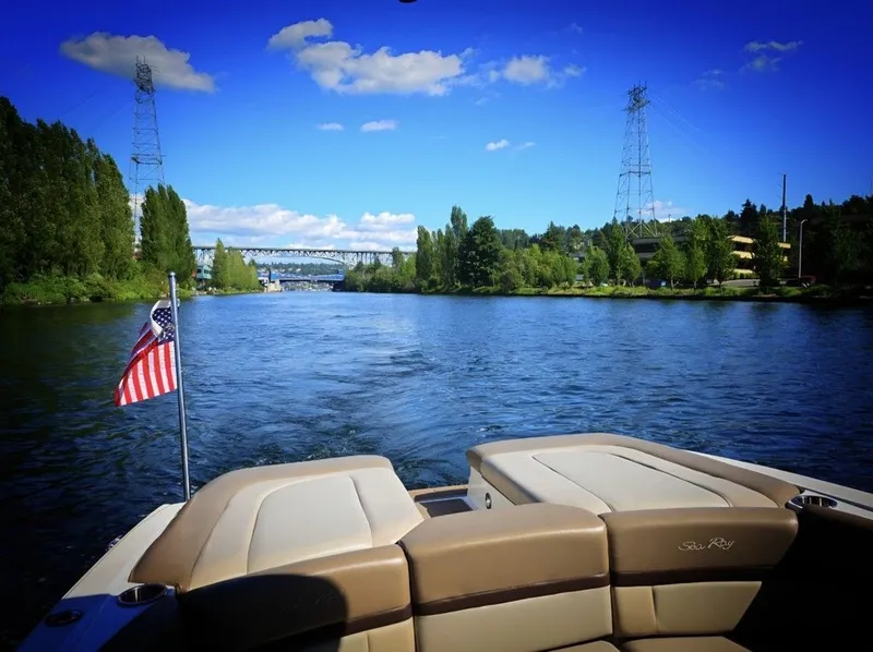 Slide: The Image of Rear view of a Sea Ray SLX 250 boat on a river with a bridge in the background. - 8