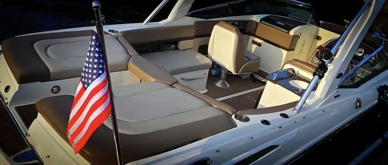 Slide: The Image of The image shows the interior of a 2012 Sea Ray SLX 250 boat with an American flag. - 3