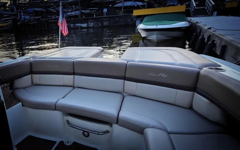 Slide: The Image of The image shows the stern of a 2012 Sea Ray SLX 250 boat with gray upholstery. - 7