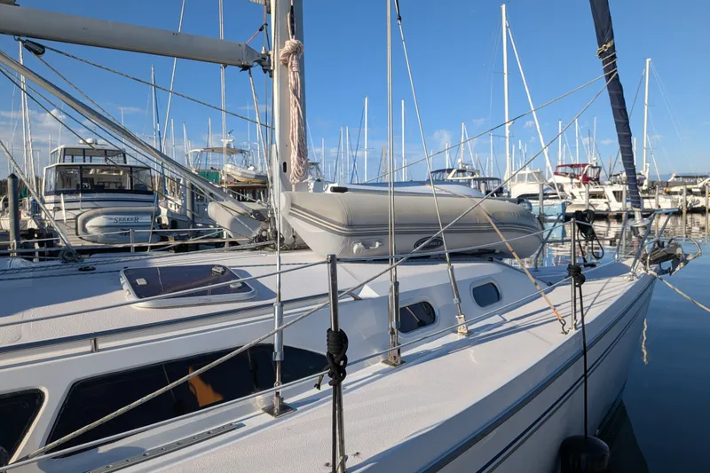 Slide: The Image of Catalina 350 sailboat from 2003 docked in a marina with clear blue skies. - 6