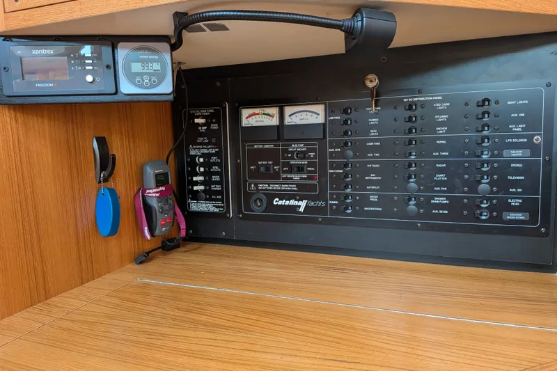 Slide: The Image of Electrical control panel of a 2003 Catalina 350 yacht with various switches and meters. - 29