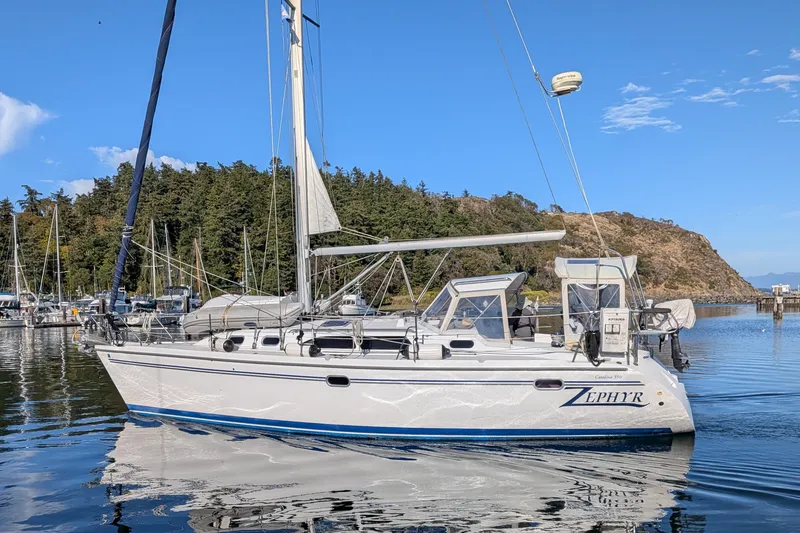Slide: The Image of Catalina 350 sailboat from 2003, named Zephyr, docked in a scenic marina. - 2