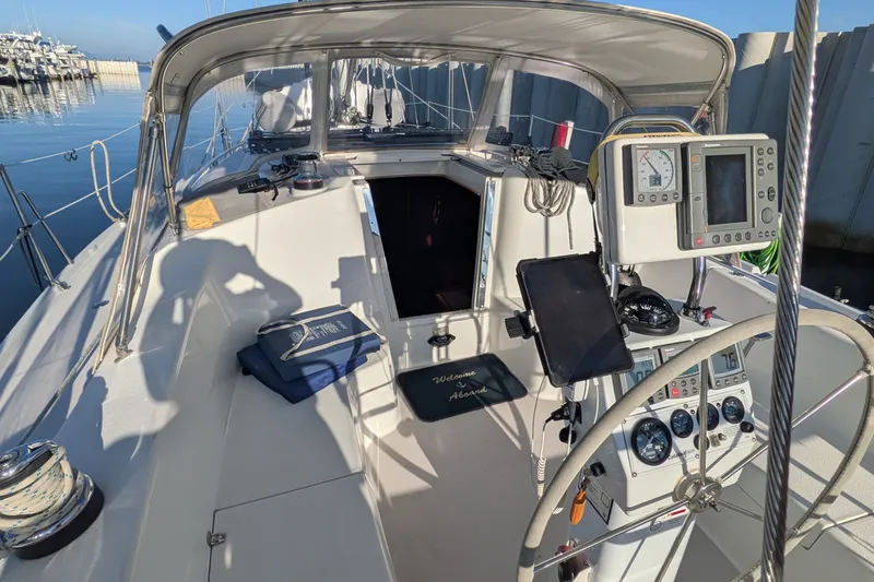 Slide: The Image of 2003 Catalina 350 sailboat cockpit with navigation instruments and open cabin entrance. - 15