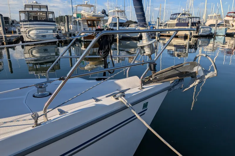 Slide: The Image of Catalina 350 sailboat from 2003 docked in a marina with calm waters. - 7