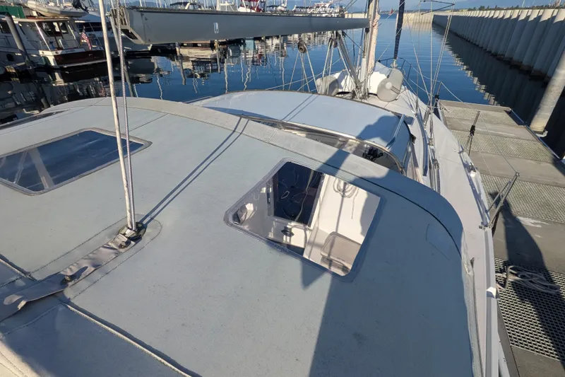 Slide: The Image of Catalina 350 sailboat from 2003 docked at a marina, showcasing deck and rigging. - 11
