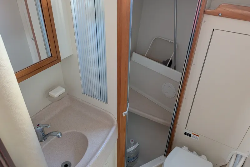 Slide: The Image of Bathroom interior of a 2003 Catalina 350 sailboat, featuring a sink and shower area. - 37