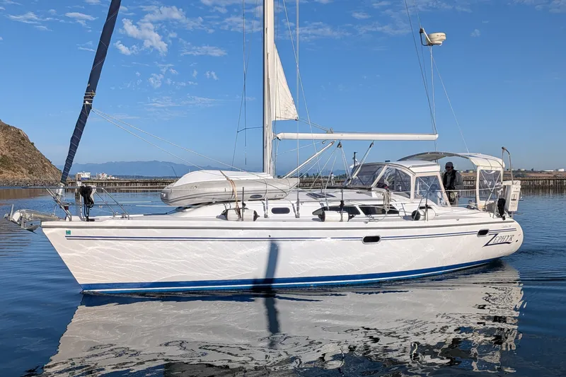 The Image of Catalina 350 sailboat from 2003 on calm water under a clear blue sky. - 0