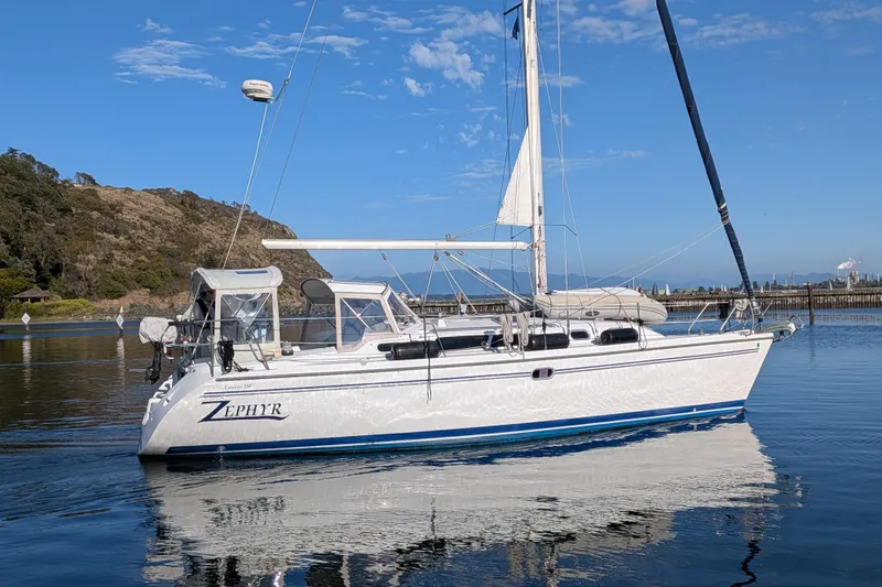 Slide: The Image of 2003 Catalina 350 sailboat "Zephyr" on calm water, clear sky background. - 4
