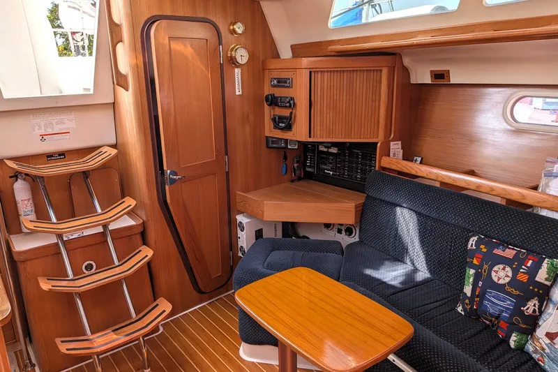 Slide: The Image of Interior of a 2003 Catalina 350 sailboat with wooden finishes and nautical decor. - 26