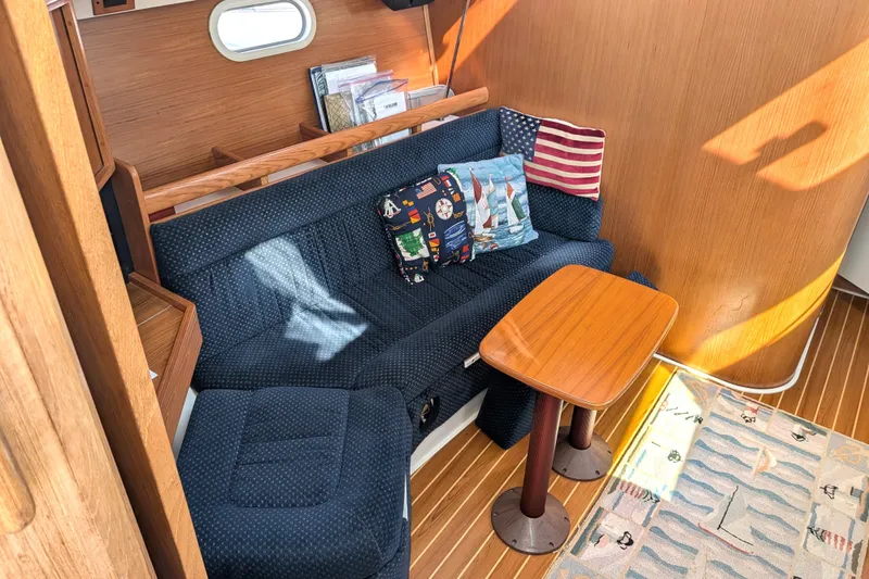Slide: The Image of Cozy interior of 2003 Catalina 350 sailboat with blue sofa and nautical-themed decor. - 20