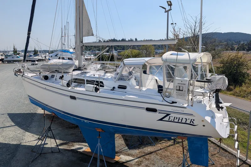Slide: The Image of 2003 Catalina 350 sailboat "Zephyr" on stands in a marina setting. - 44