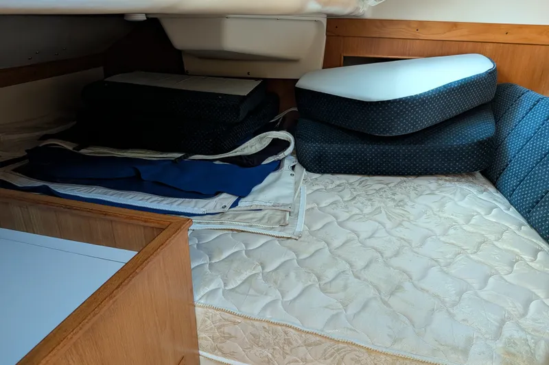 Slide: The Image of Interior cabin of a 2003 Catalina 350 sailboat with cushions and bedding. - 33
