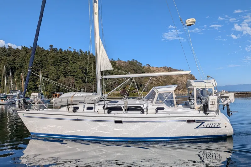 Slide: The Image of Sailboat Catalina 350, 2003 model, docked in a serene marina with lush greenery. - 1