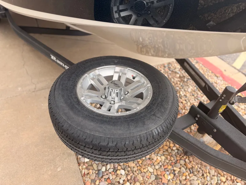 Slide: The Image of A Ranger 1850 MS boat on a trailer with a spare tire. - 19