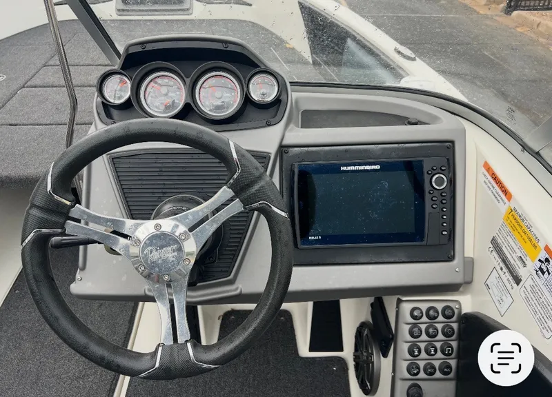 Slide: The Image of The image shows the cockpit of a 2024 Ranger 1850 MS boat with modern steering and instruments. - 17