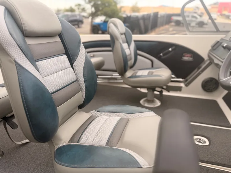 Slide: The Image of The image shows the interior of a 2024 Ranger 1850 MS boat with cushioned seats. - 23