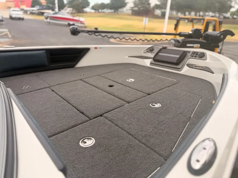Slide: The Image of The image shows the bow deck of a 2024 Ranger 1850 MS boat with gray carpeting. - 21