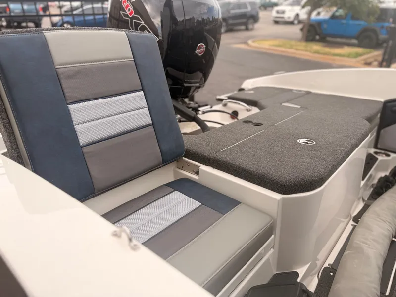 Slide: The Image of The image shows the seating area of a 2024 Ranger 1850 MS boat with gray and blue upholstery. - 25