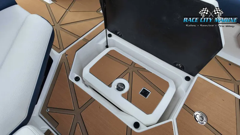 Slide: The Image of The image shows a storage compartment lid on a boat with a wood-like finish and a black handle. - 36