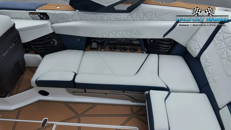 Slide: The Image of The image shows the luxurious interior of a Nautique P23 boat with white and blue upholstery. - 30