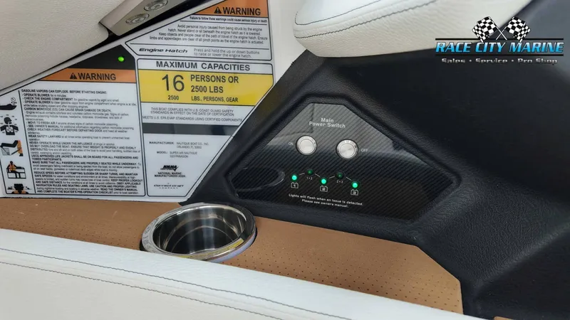 Slide: The Image of Interior view of a 2027 Nautique P23 with warning labels and a main power switch. - 50