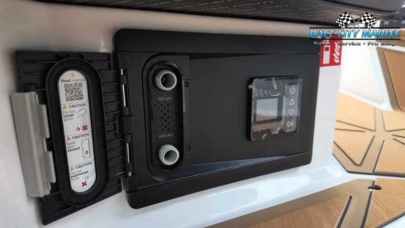 Slide: The Image of Close-up of a control panel with controls and warning labels on a Nautique P23 boat. - 38
