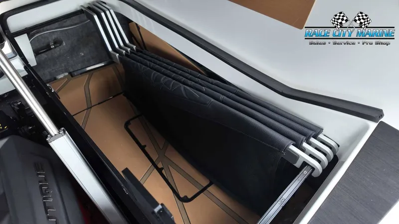 Slide: The Image of A storage compartment in the boat with several black cushions neatly stacked. - 24