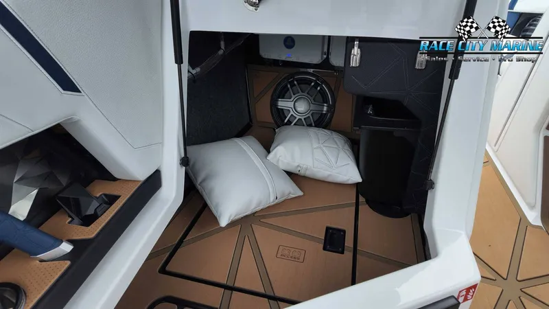 Slide: The Image of The interior of a 2027 Nautique P23 features cushions and a speaker on the floor. - 35