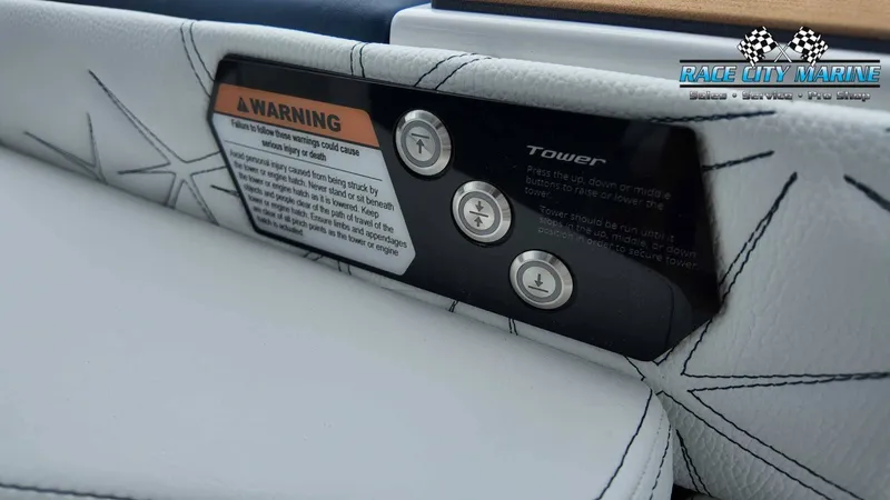 Slide: The Image of Close-up of a 2027 Nautique P23 boat with control buttons and a warning label. - 42