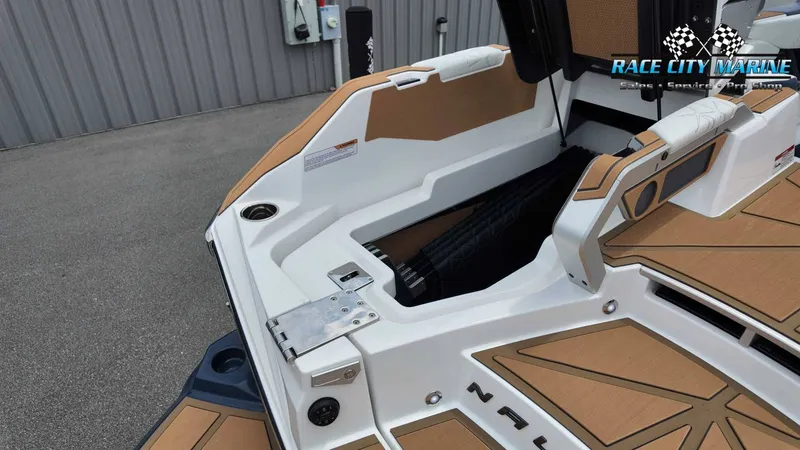 Slide: The Image of The image shows the stern of a 2027 Nautique P23 boat with brown accents. - 17