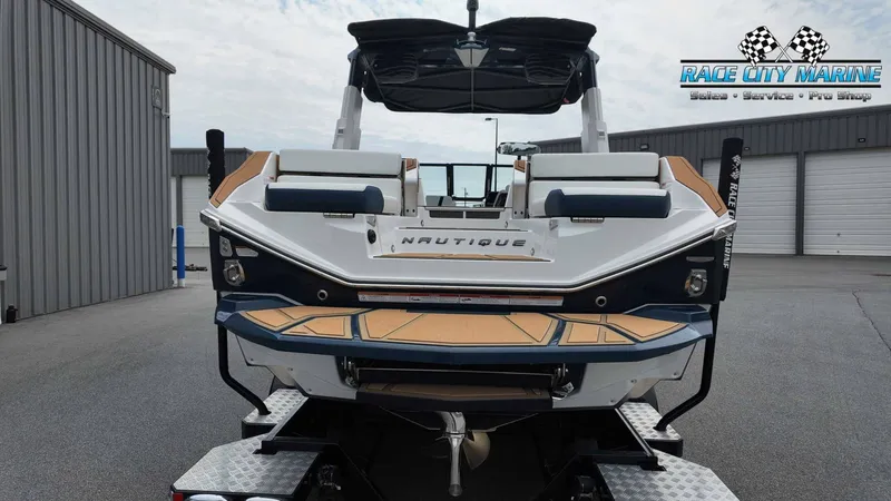 Slide: The Image of The image shows a 2027 Nautique P23 boat on a trailer in a warehouse setting. - 4